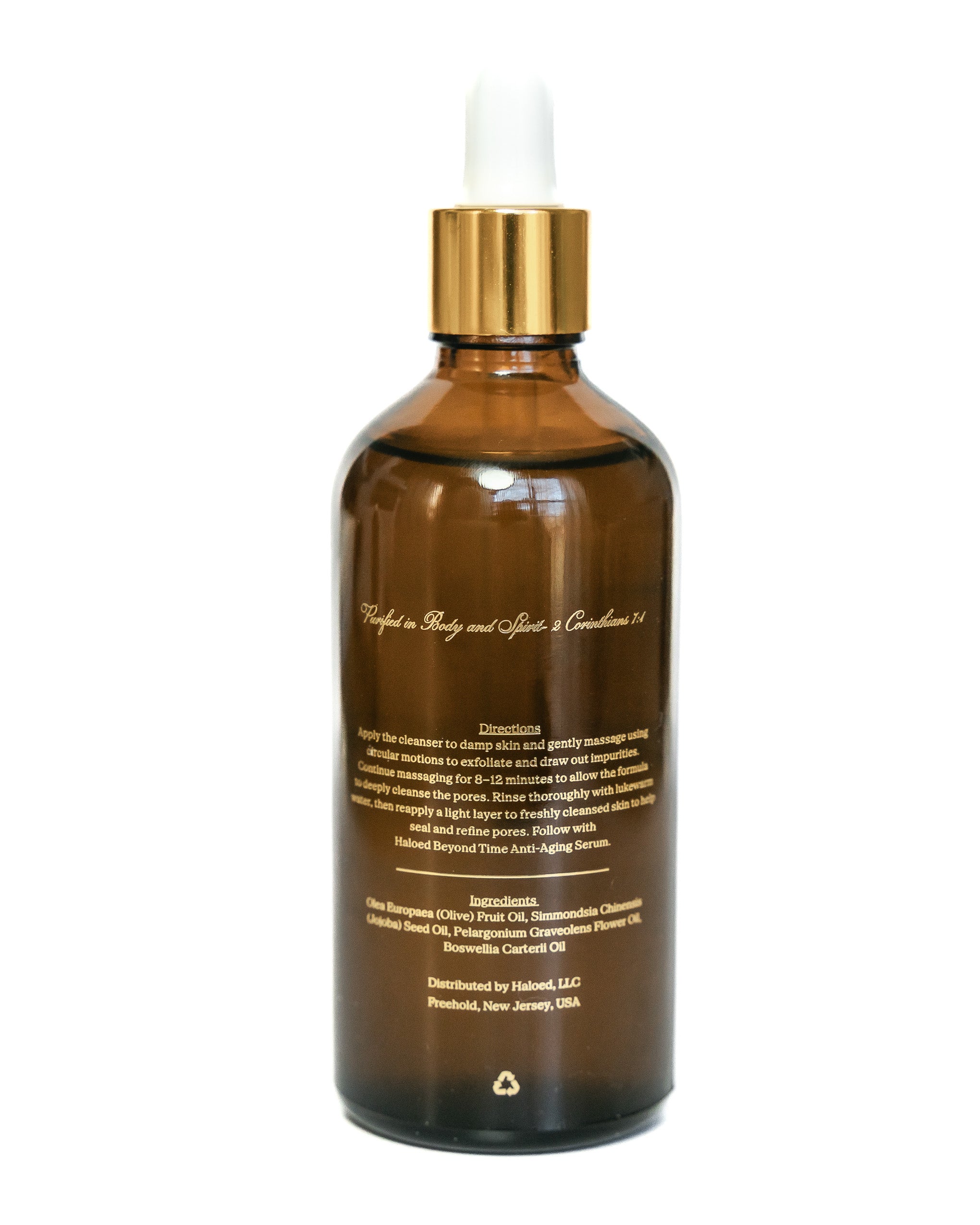 Brown glass bottle with gold cap on a white background