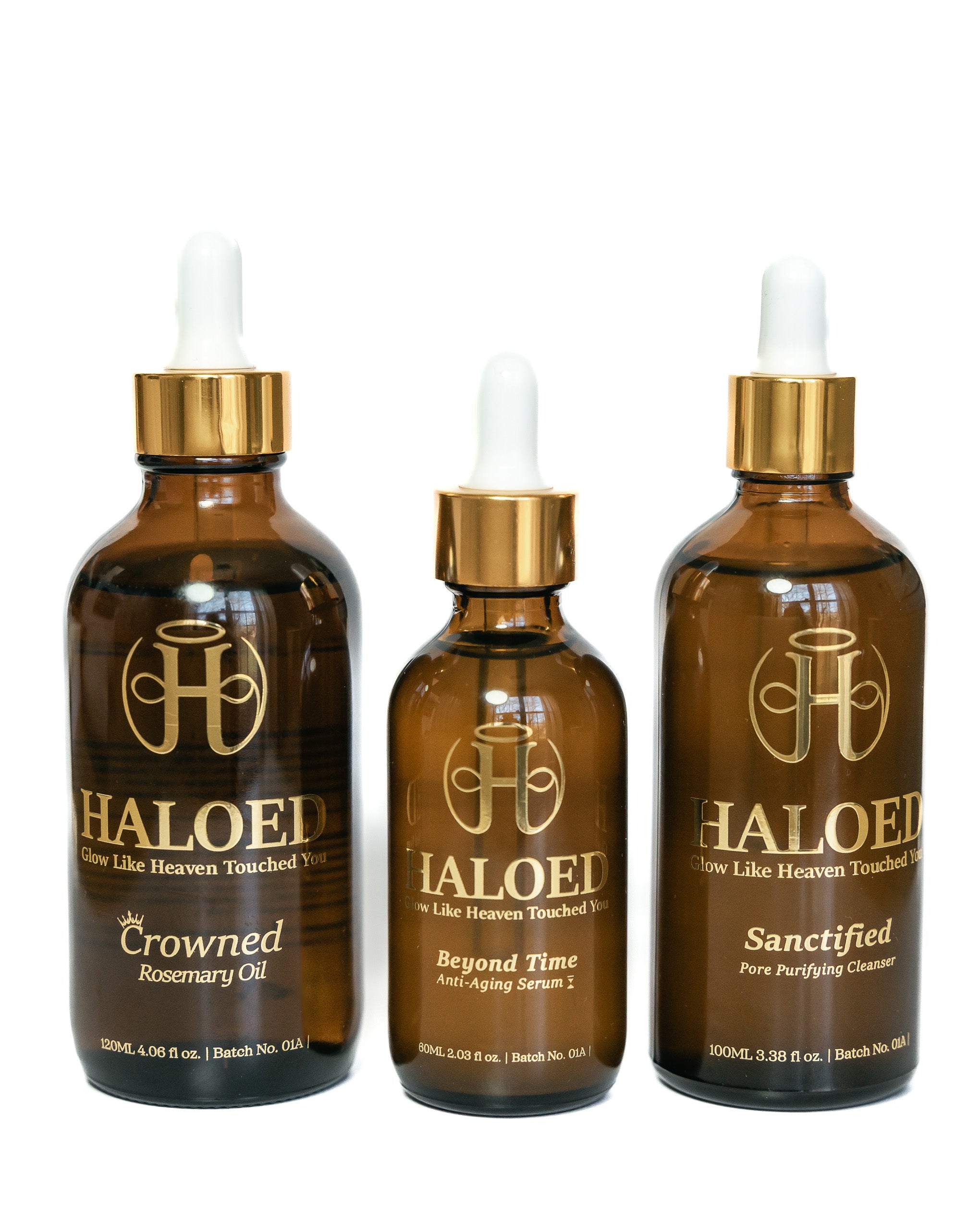 Three bottles of Haloed oil products on a white background