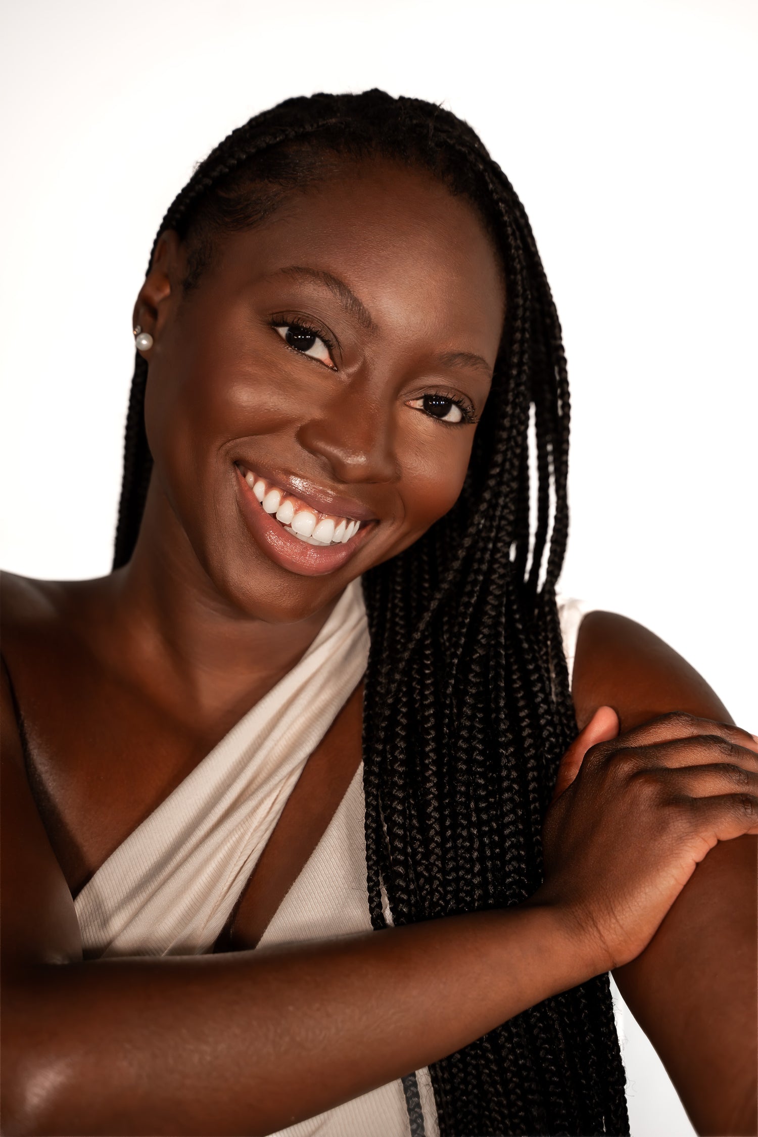 Woman with braided hair smiling against a white background