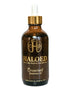 Brown bottle of Haloed Crowned Rosemary Oil with gold cap on a white background